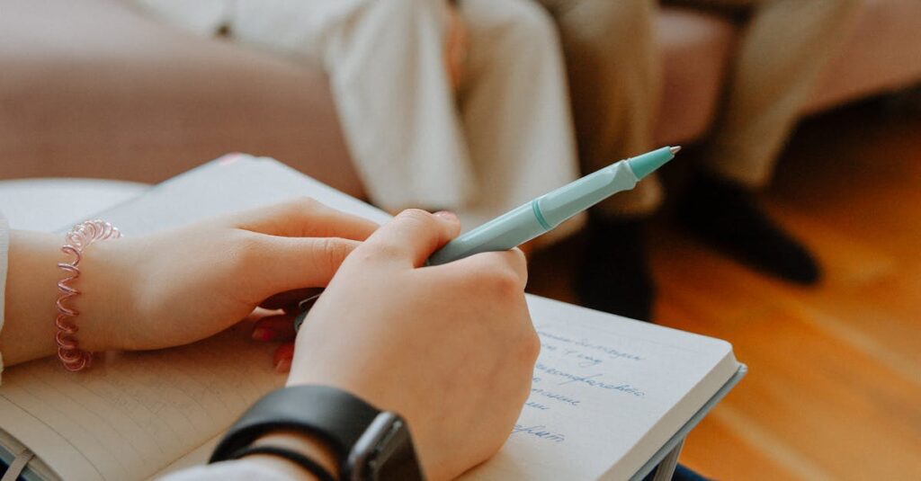 A therapist takes notes while counseling a couple in an indoor session.